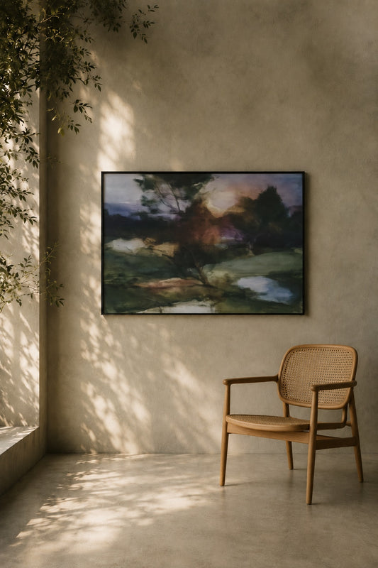 Woven chair in a room with a painting of a landscape on the wall.
